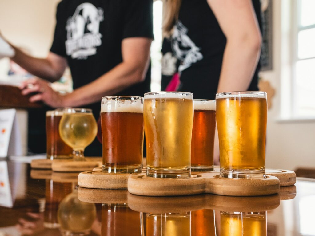 A selection of different beers on a counter in a bar.